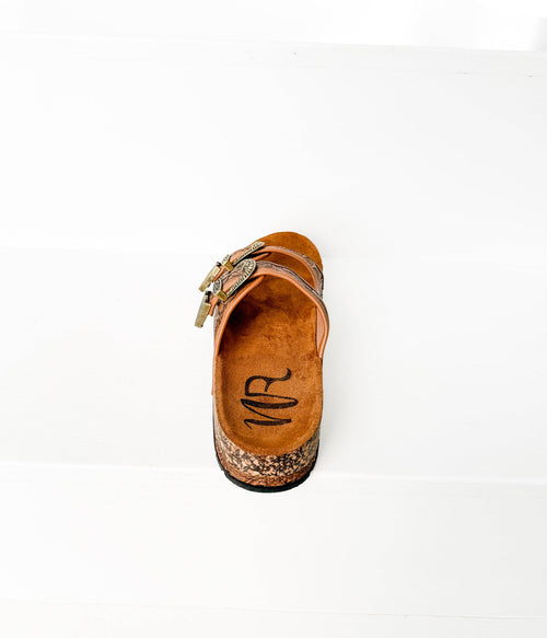 Brown sandal with cork sole on a white background