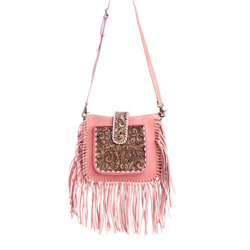 Pink crossbody bag with fringe and intricate design on a white background