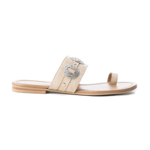 Beige sandal with a decorative buckle on a white background