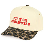 Beige cap with red text 'PUT IT ON MY DAD'S TAB' and camouflage brim on a white background