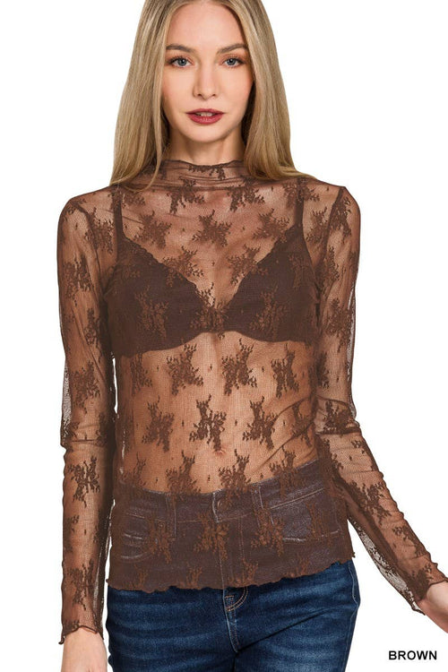 Woman wearing a sheer brown lace top with long sleeves on a white background