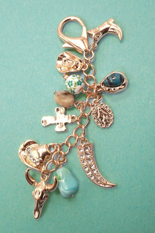 Keychain with various charms on a teal background