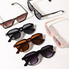 Collection of sunglasses with different frame colors and lens shades on a white background