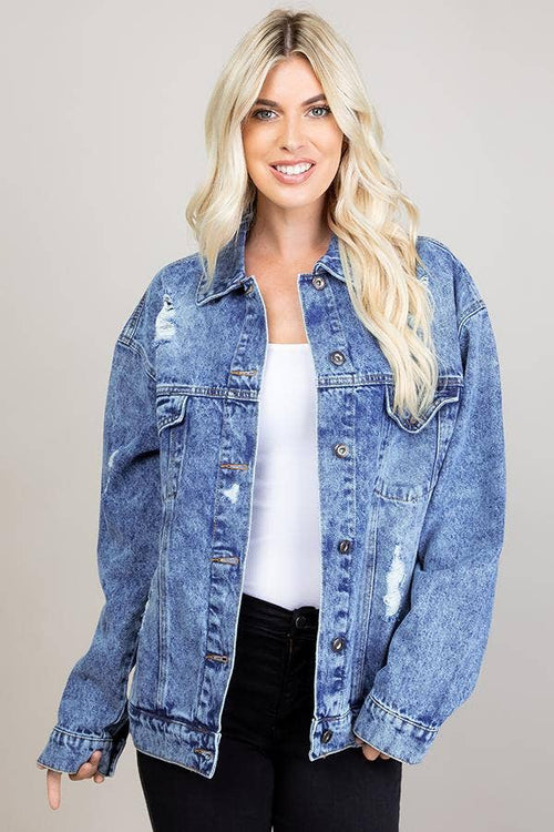 Woman wearing a blue denim jacket on a plain background