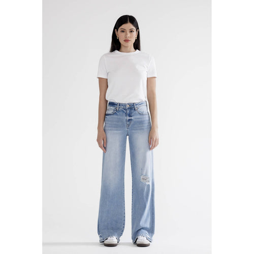 Person wearing a white t-shirt and light blue jeans on a white background