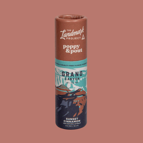 Product packaging with 'The Landmark Project' and 'Poppy & Pout' branding on a brown background