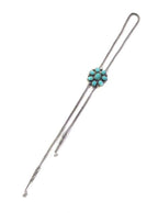 Silver bolo necklace with turquoise stones on a white background
