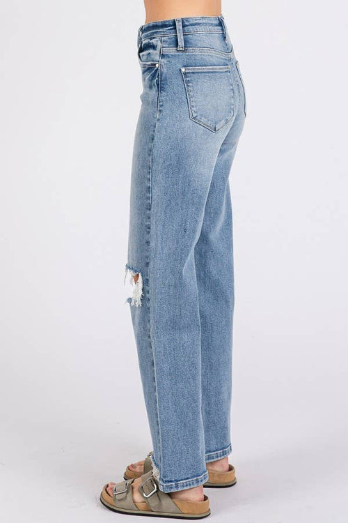 Light blue jeans with a slight distressed look on a white background