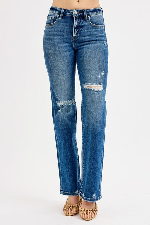 Blue jeans with distressed details on a white background