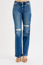 Blue jeans with distressing on a white background