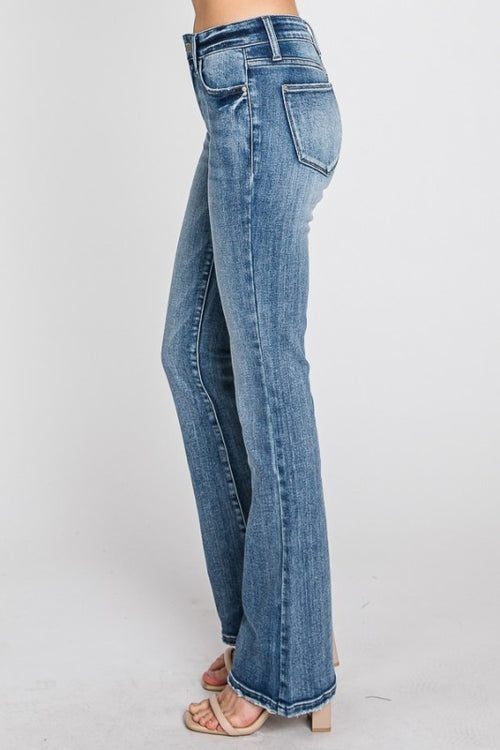Blue jeans worn by a person on a white background