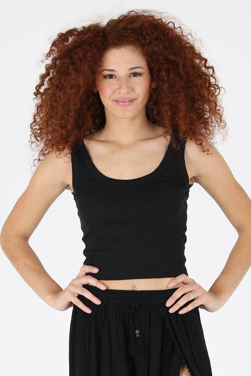Woman wearing a black tank top and skirt on a white background