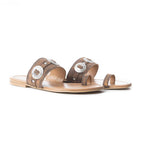 Pair of brown sandals with silver embellishments on a white background