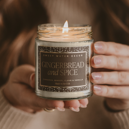 Candle labeled 'Gingerbread and Spice' held by a person