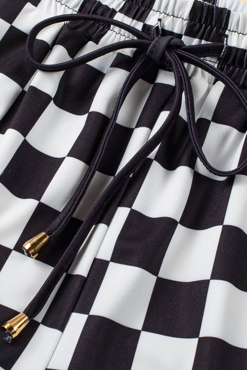 Black and white checkered fabric with drawstring and gold accents