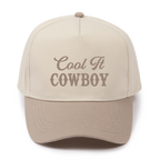 Beige cap with 'Cool It Cowboy' text on a white background