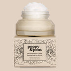 Jar of Poppy & Pout marshmallow crème exfoliating lip scrub on a beige background