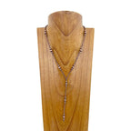 Necklace on a wooden mannequin head with a white background