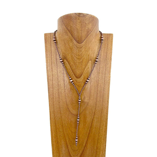 Necklace on a wooden mannequin head with a white background