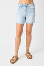 Light blue denim shorts worn by a person on a white background