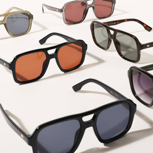 Collection of sunglasses with various lens colors and frames on a white background