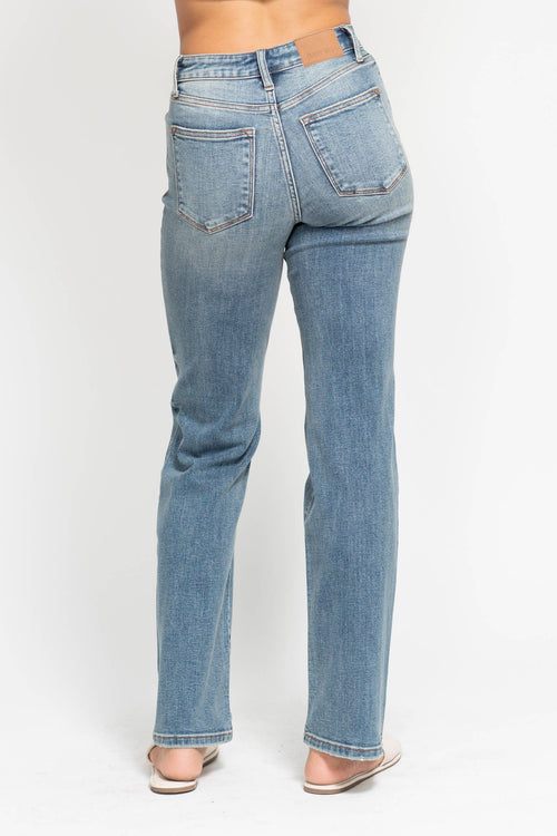 Light blue jeans worn by a person on a white background