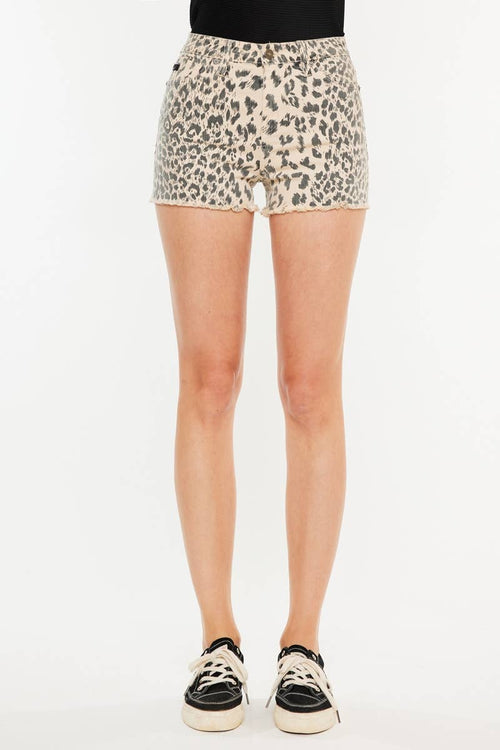 Leopard print shorts worn by a person on a white background