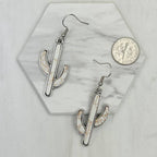 White stone cactus earrings on white background with coin for reference
