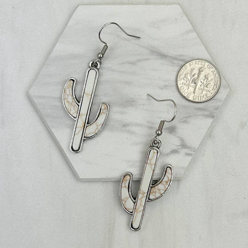 White stone cactus earrings on white background with coin for reference