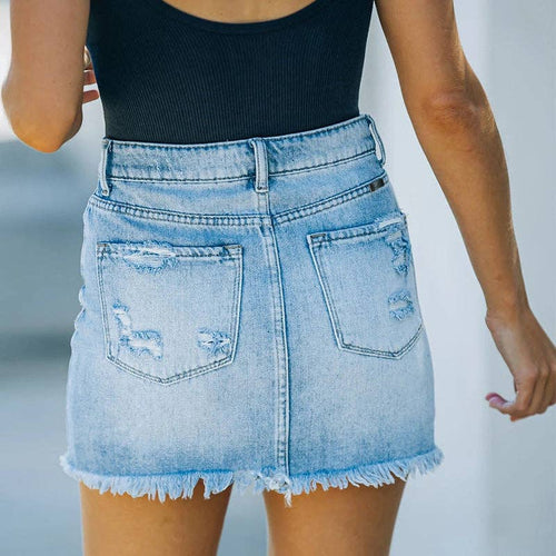 Light blue denim skirt worn by a person with a blurred background