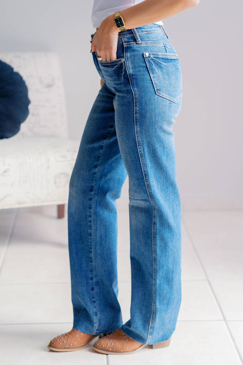 Person wearing blue jeans with a blurred background