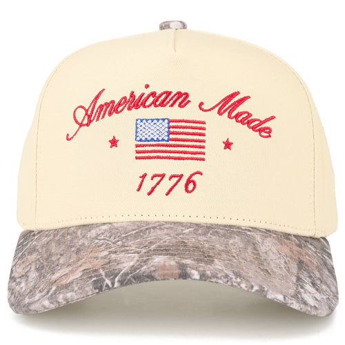 Cap with 'American Made 1776' text and American flag on a beige and camouflage visor.