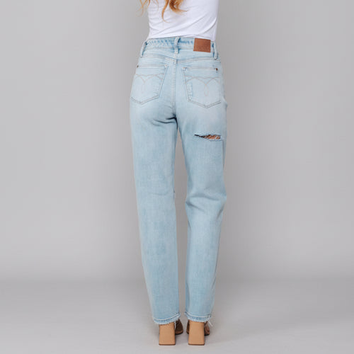 Light blue jeans worn by a person with a white background