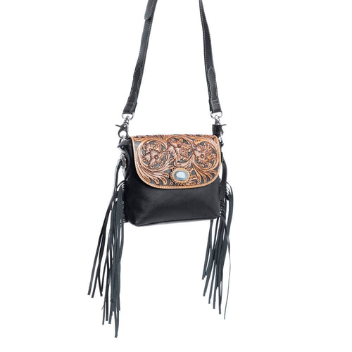 Black leather crossbody bag with decorative flap and fringes on a white background