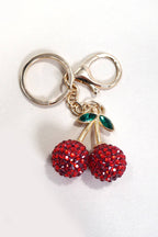 Keychain with red cherry charm on a white background