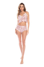 Woman wearing a pink lace lingerie set on a white background
