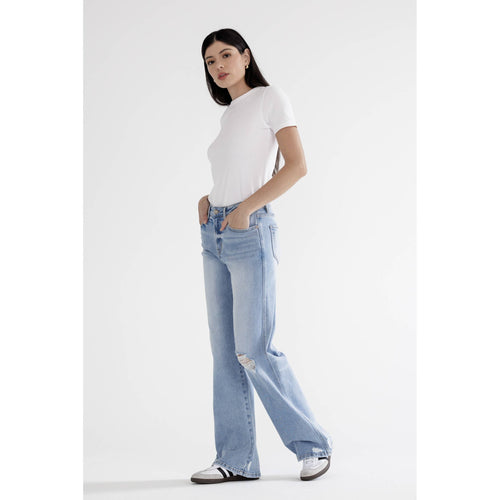 Woman wearing a white t-shirt and light blue jeans on a white background