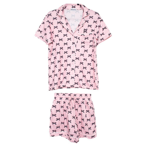 Pink pajama set with black bow pattern on a white background