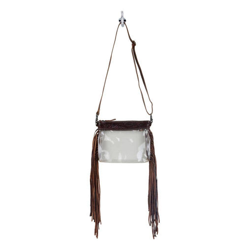 Clear handbag with brown leather fringe and strap on a white background