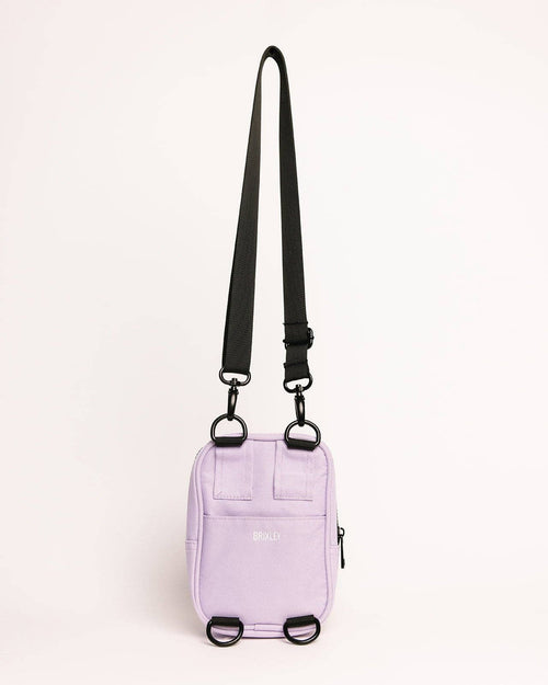 Purple bag with a black strap on a white background