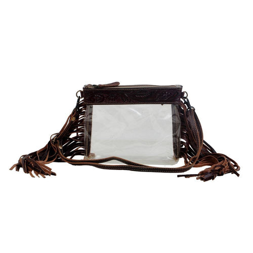 Clear handbag with brown leather straps and fringes on a white background