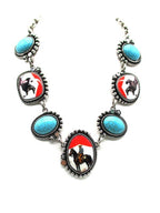 Necklace with horse and rider design on a white background