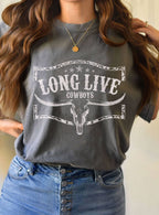 Person wearing a gray t-shirt with 'Long Live Cowboys' print, standing against a neutral background.