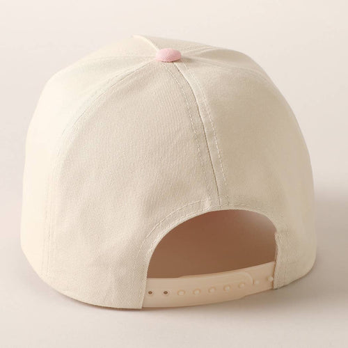 Beige baseball cap with pink button on a light gray background