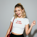 Woman wearing a a white t-shirt with red text.