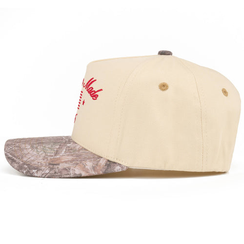 Beige cap with camouflage brim on a white background