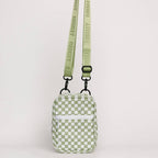 Green checkered bag with a strap on a light gray background