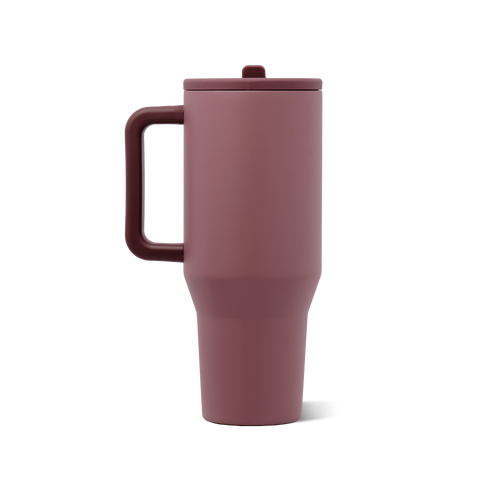 A matte dusty rose travel tumbler with an integrated handle, matching lid, and a tapered bottom, shown on a solid white background.