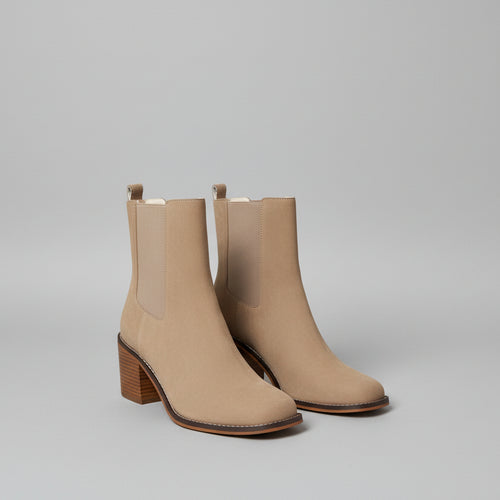 Beige ankle boots with a white background