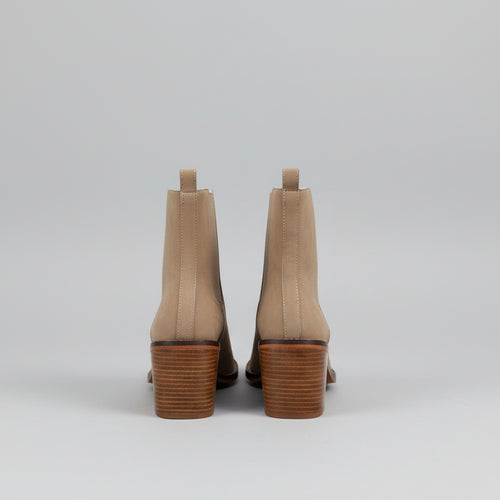 Beige ankle boots with a white background